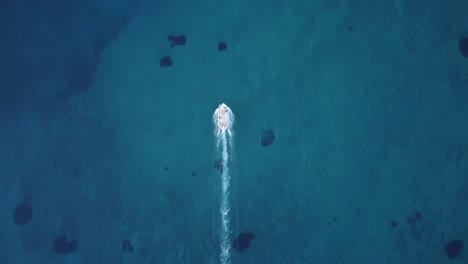 cinematic fishermen boat leaving a long water trail behind it self