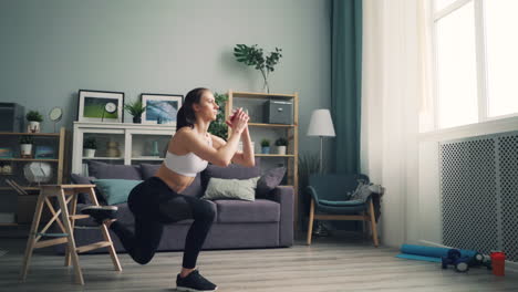 woman doing single leg squat at home