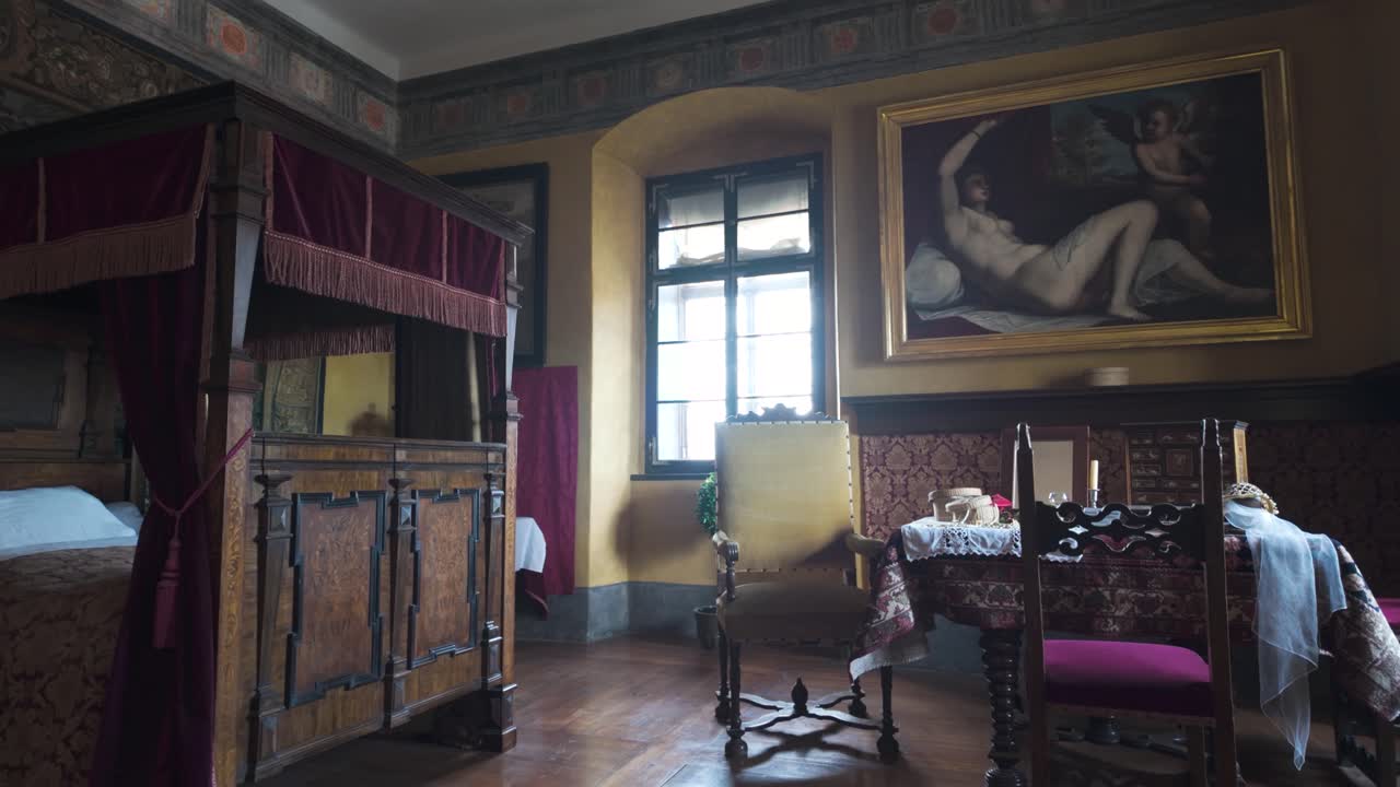 Explore the richly decorated bedroom inside Cesky Krumlov Castle. This stately room reflects the grandeur of the Bohemian Rosenberg family's architectural legacy.