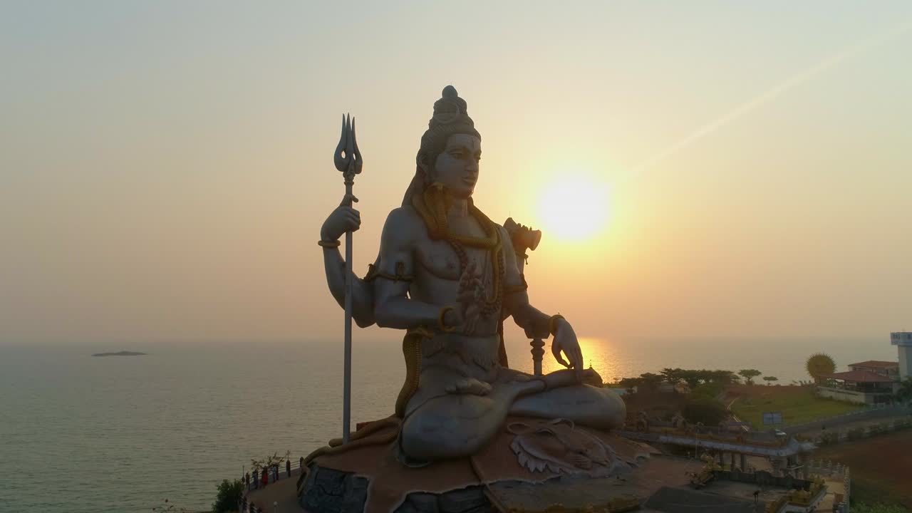 murudeshwar shiva statue drone shot by sea sunset behind south india drone