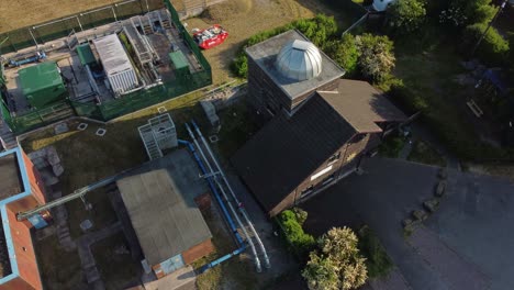 Aerial-view-circling-Pex-hill-Leighton-observatory-silver-dome-rooftop-on-hilltop-farmland-at-sunrise