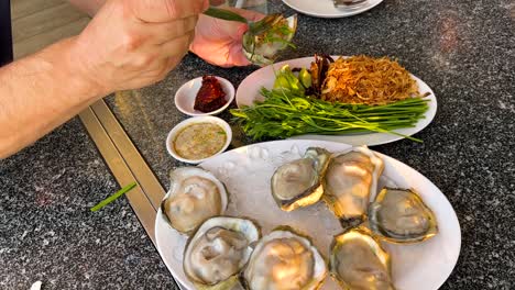 dining experience with oysters and thai dishes