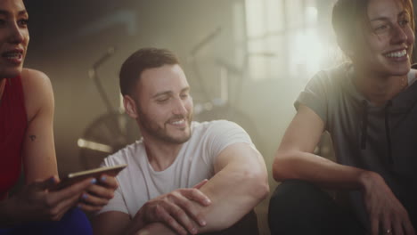 friends relaxing and talking after workout