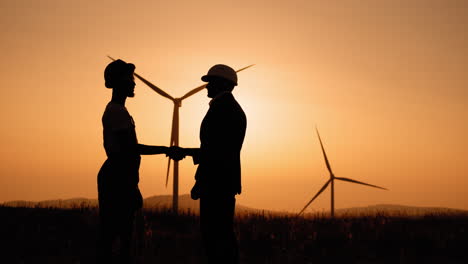 business deal at wind farm sunset