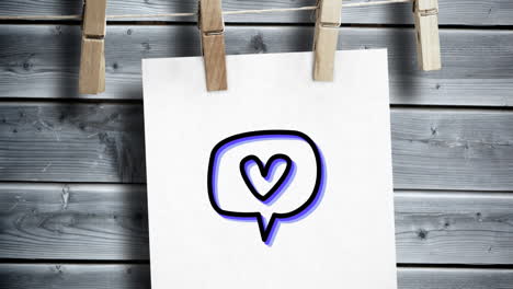 animation of a colourful speech bubble with heart in it, written on a piece of paper