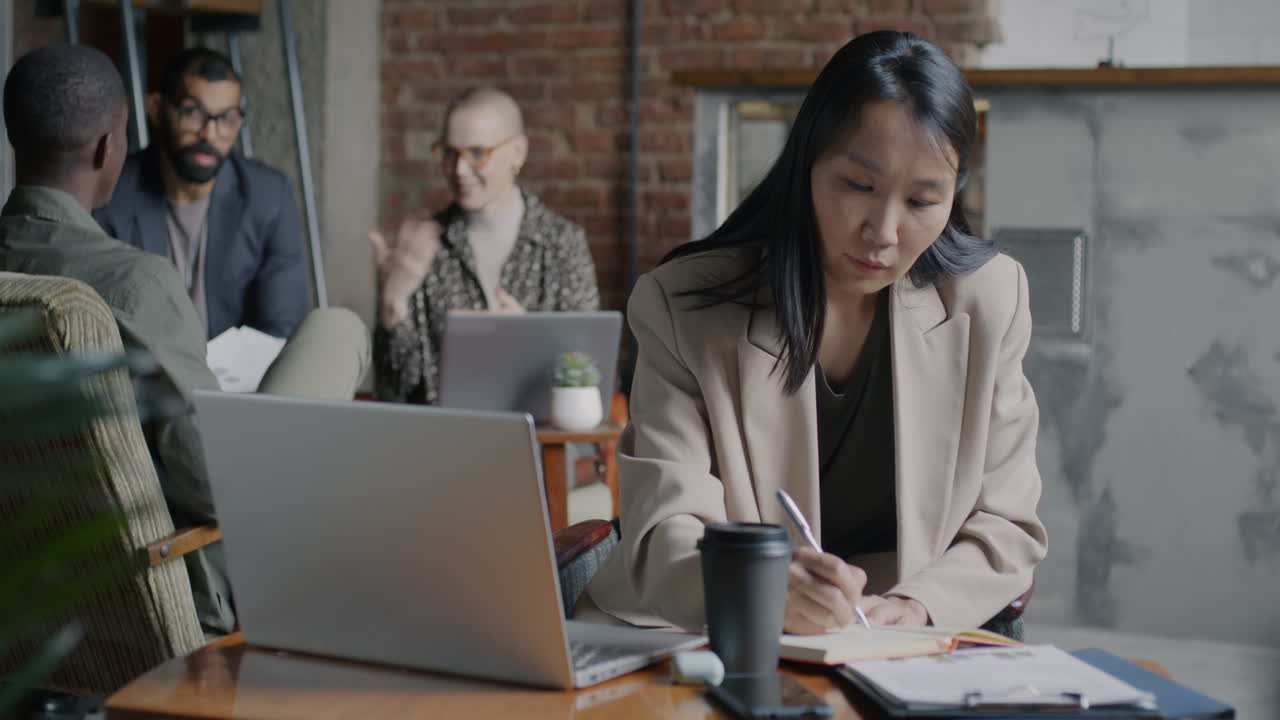 Businesswoman taking notes in a cafe
