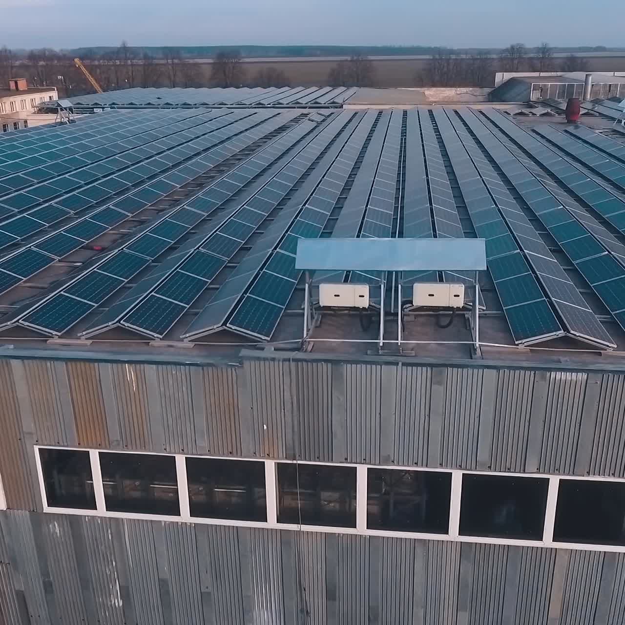 Many solar panels on a roof of a huge building. Sunny batteries to receive alternative energy from the sun. Aerial view.
