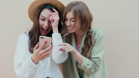 two friends looking at a smartphone
