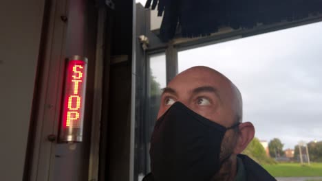 male opening car wash workplace wearing ppe corona virus face mask at stop sign handheld