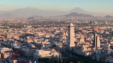 Drone-shot-of-downtown-mexico-city-and-volcanoes