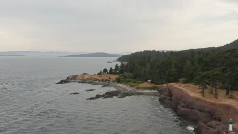 Stunning-Drone-Shot-Flying-Over-The-Natural-Beautiful-Shoreline-of-Vancouver-on-a-windy-cloudy-day