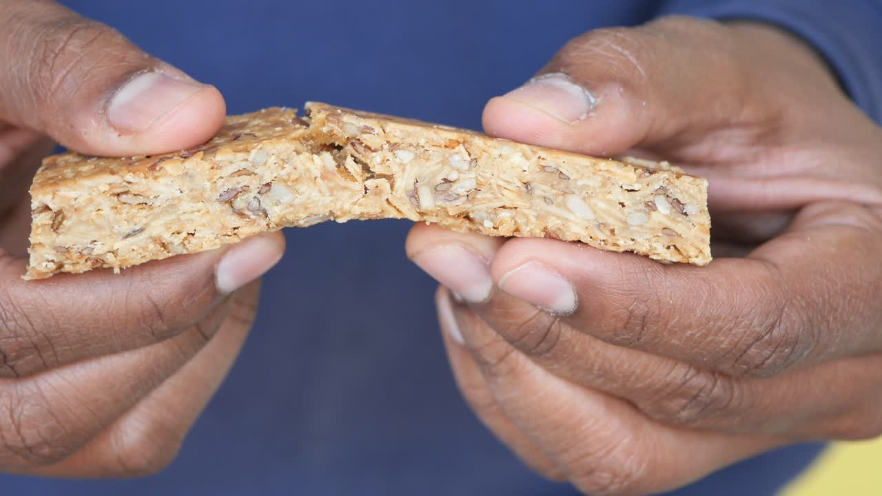 Person holding a granola bar