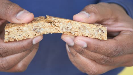 person holding a granola bar