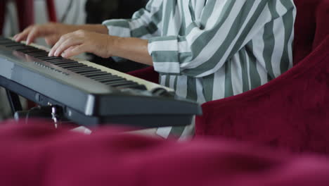 a man in a striped shirt and glasses looking focused indoors