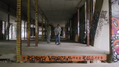 caucasian boys skateboarding in a ruined building.