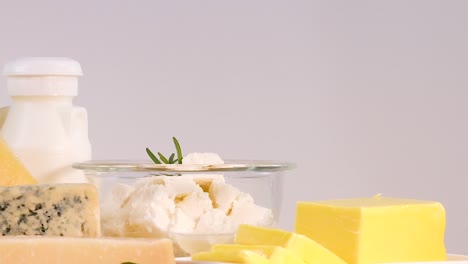 A selection of dairy items including milk, cheese, and butter on a wooden surface.