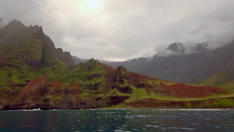 4K-Hawaii-Kauai-Boating-on-ocean-floating-left-to-right-from-mountain-shoreline-to-Na-Pali-Coast-State-Wilderness-Park