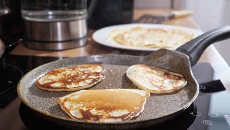 close-up of mini pancakes on a hot frying pan