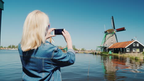 Woman-Takes-Pictures-Of-Dutch-Windmills