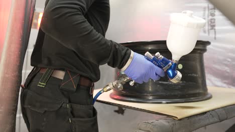 automotive repair shop, working on a wheel refurbishment