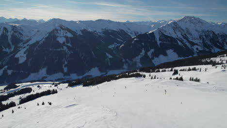 skiers enjoying winter sports on ski slope on reiterkogel mountain in hinterglemm, austria