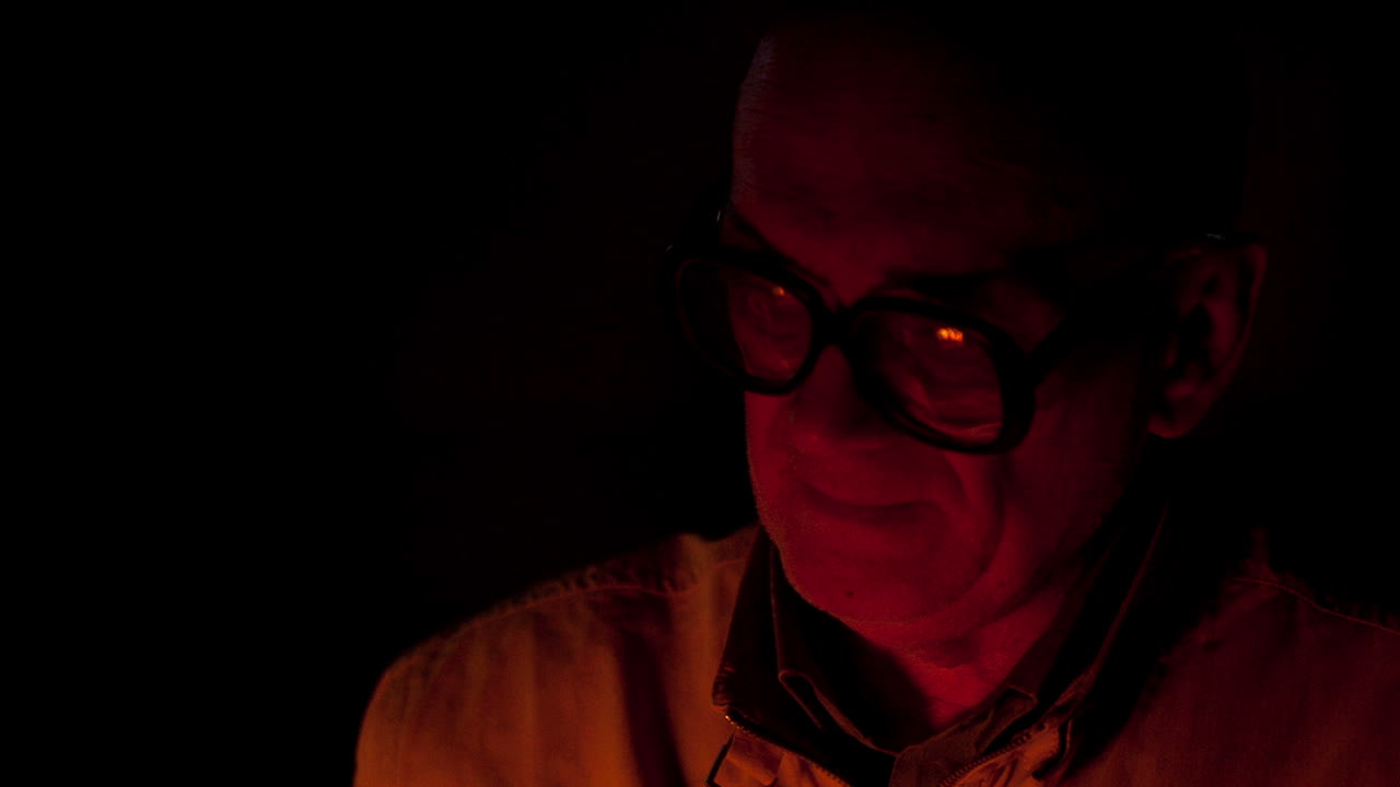 Old man in the light of fire