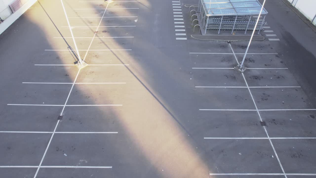 Empty Parking Lot Space With Lamppost During Daytime. Aerial Drone