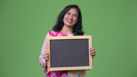 madura feliz hermosa mujer india mostrando la pizarra