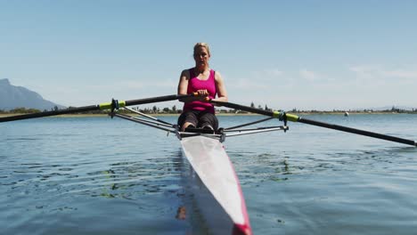 Senior-caucasian-woman-rowing-boat-on-a-river
