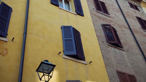 italian building with shutters and lamppost