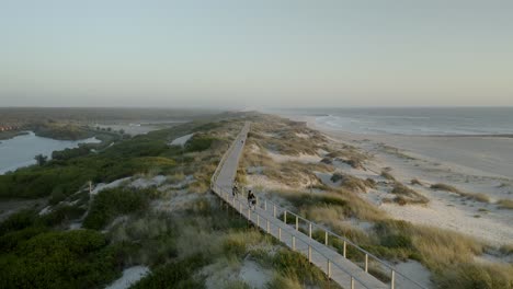 tourists riding bikes on boardwalk