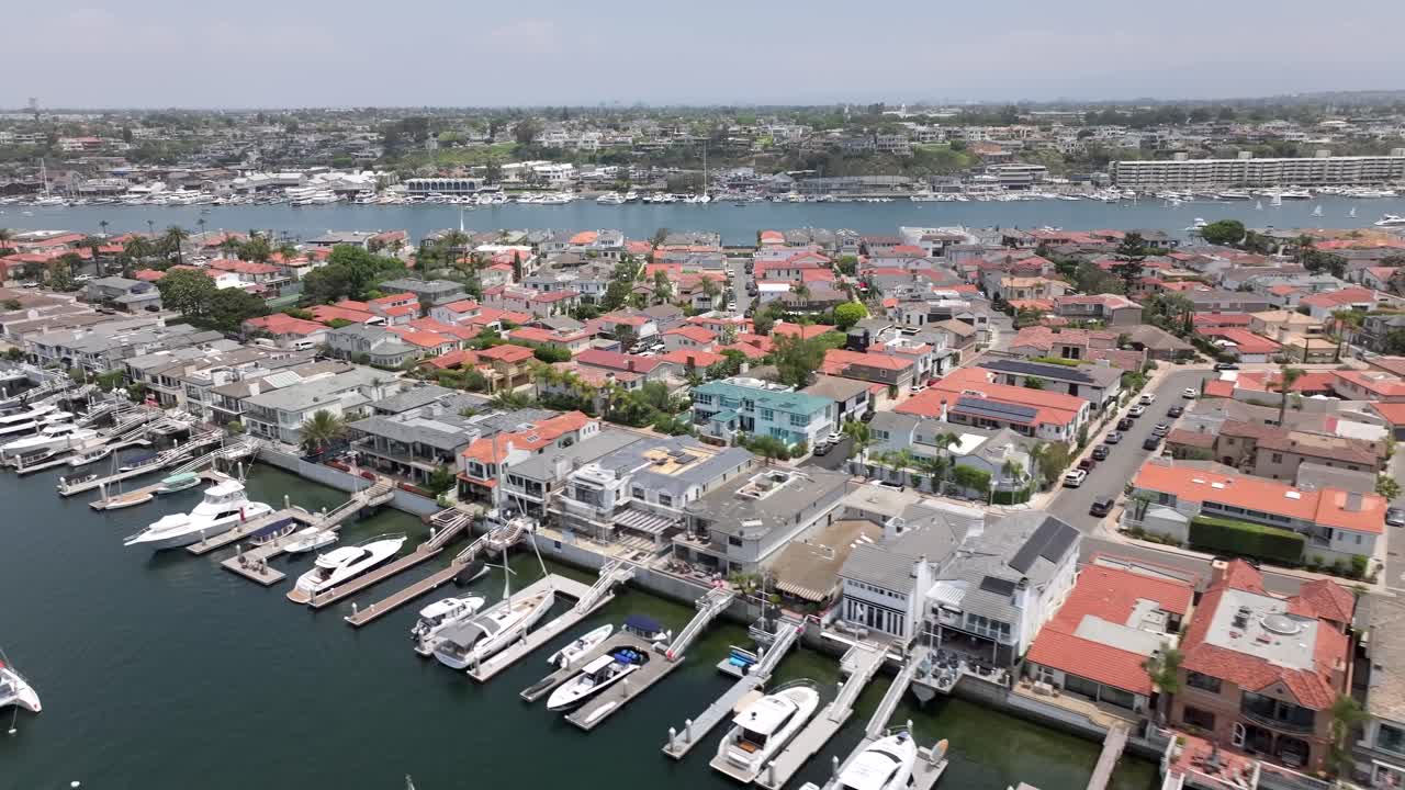Luxury Boats And Yachts At Waterfront Mansions At Lido Isle In Newport Bay, California. Aerial Shot.