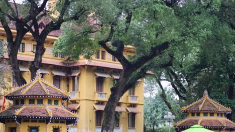 motorbikes and cars pass by a traditional structure