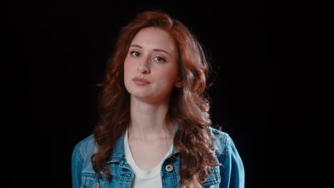 a young caucasian woman turns her head and looks at the camera