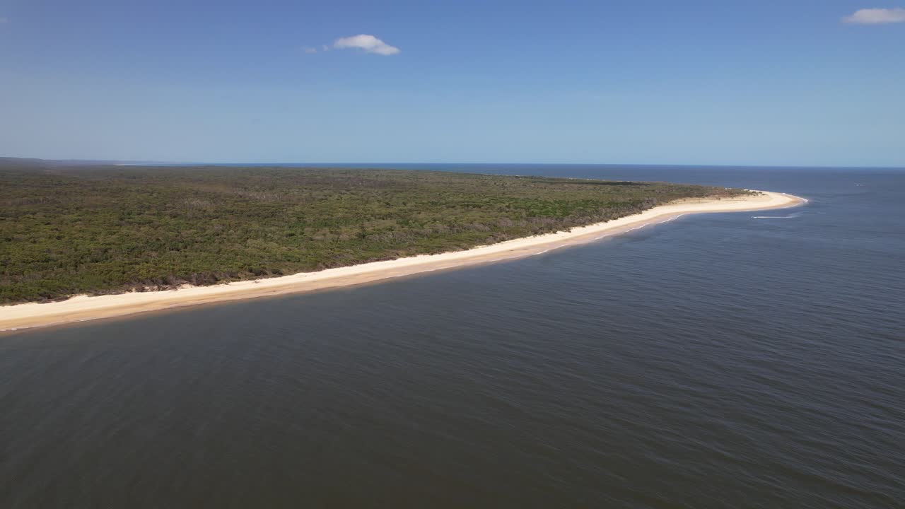 Forested Inskip Peninsula With Sandy Beach On Sunny Day In Queensland, Australia. wide aerial shot
