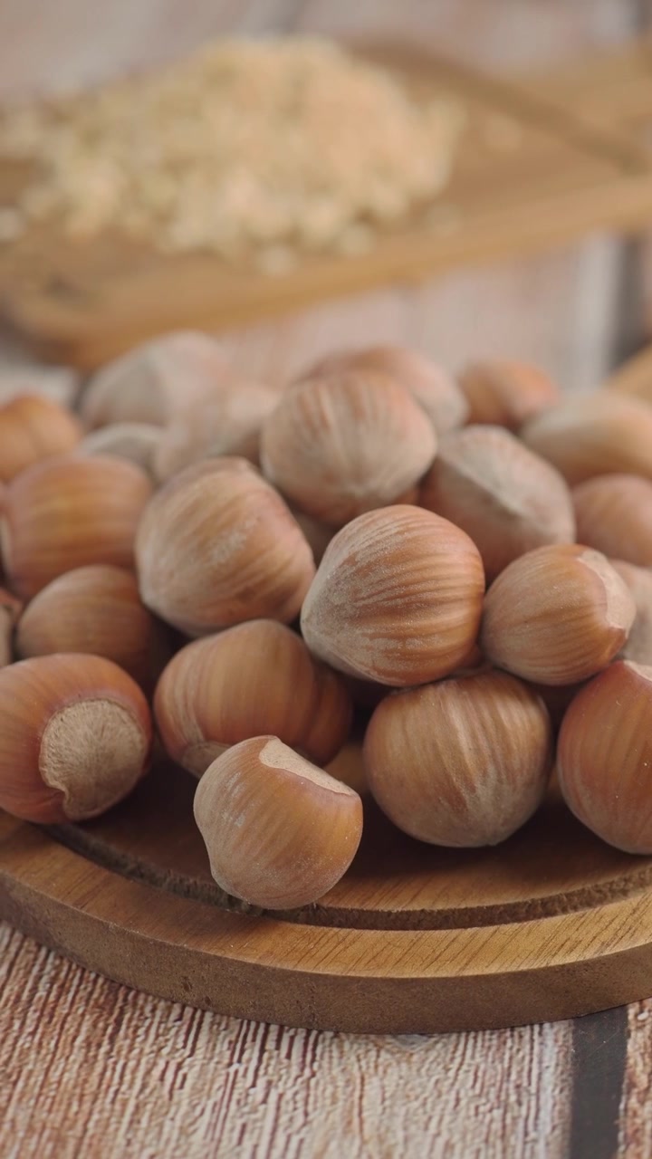 Pile of Fresh Hazelnuts on a Wooden Board