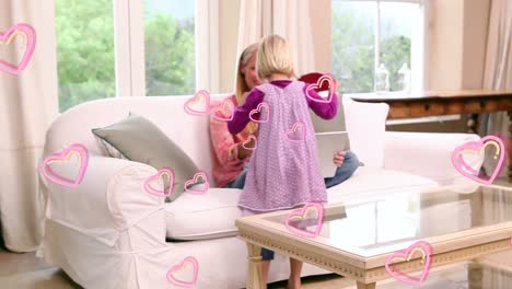 animation of pink hearts over happy caucasian mother and daughter with red heart