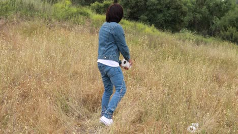 A-man-throws-toilet-paper-to-a-woman-like-a-football-in-a-field-during-the-Covid19-coronavirus-pandemic-epidemic