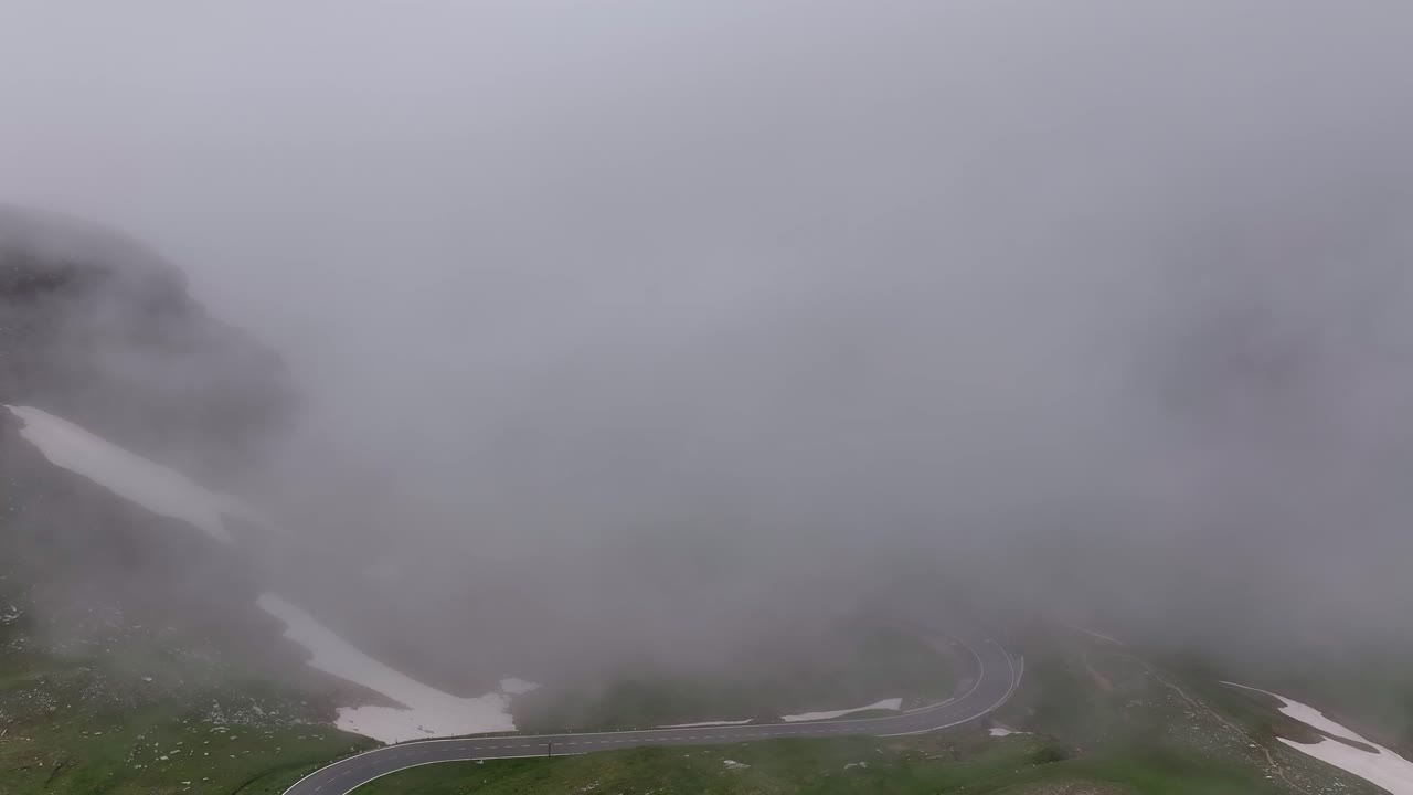A foggy view of the Großglockner Hochalpenstraße on a cloudy day with limited visibility