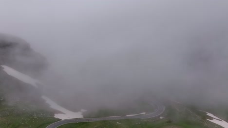 a foggy view of the großglockner hochalpenstraße on a cloudy day with limited visibility