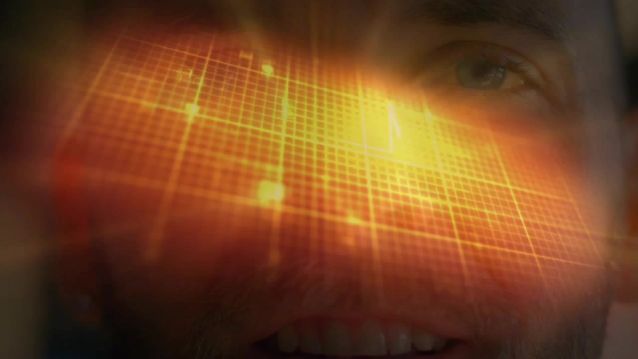Close-up of Man Looking at Glowing Digital Data Interface