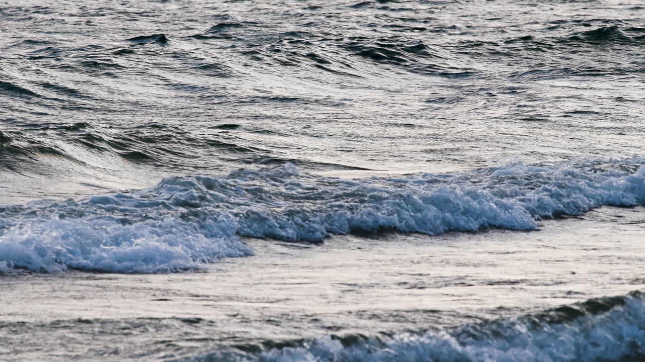 Waves in the water hitting shoreline in slow motion