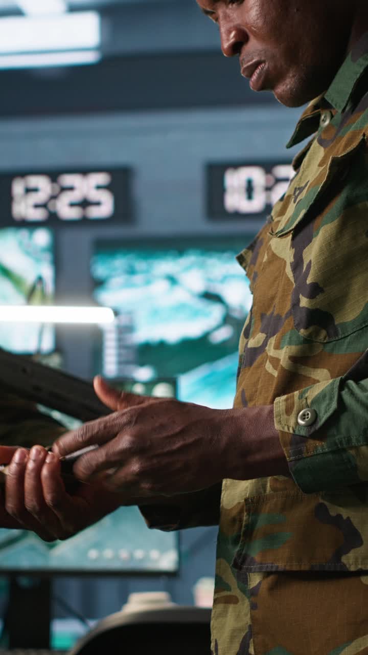 Vertical video Soldiers doing checkup on rifles and pistols in command post