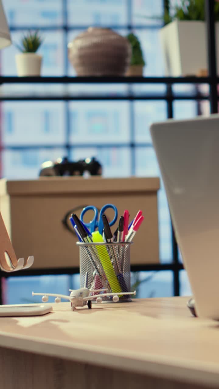 Empty Office Desk with Laptop, Headphones, and Stationery