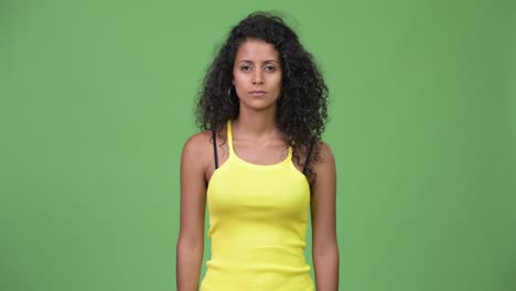 young beautiful hispanic woman pointing up