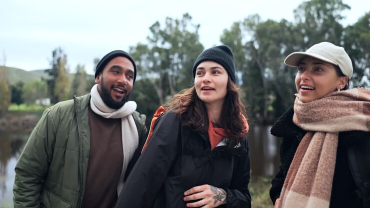 Friends, hiking and people at a lake in nature