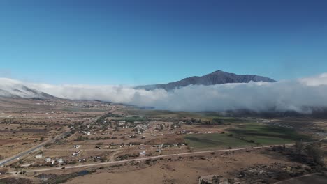 Aerial-view-of-a-town-between-valley-and-mountains-in-the-town-of-Tafí-del-Valle-in-Tucumán,-Argentina