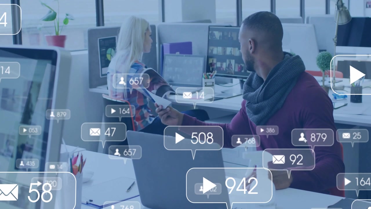 Office colleagues exchanging report while floating social icons appearing tracking media engagement