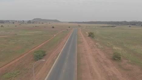 aerial two cyclists on a busy road