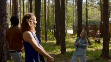 friends playing volleyball in the woods